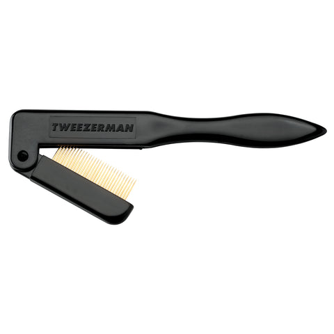 TWEEZERMAN faltbarer Wimpernkamm in schwarz mit vergoldeten Metallzinken, halb zugeklappt.